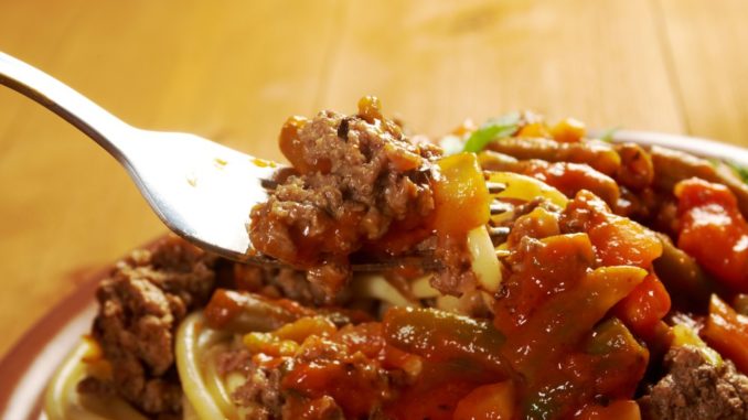pasta with beef ,vegetable tomato sauce on wooden table